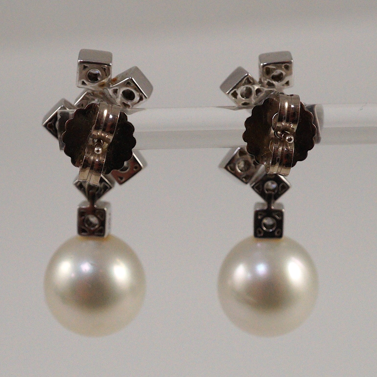 A modern pair of 18ct white gold, single stone South Sea pearl and eight stone diamond cluster set drop earrings, by Kailis